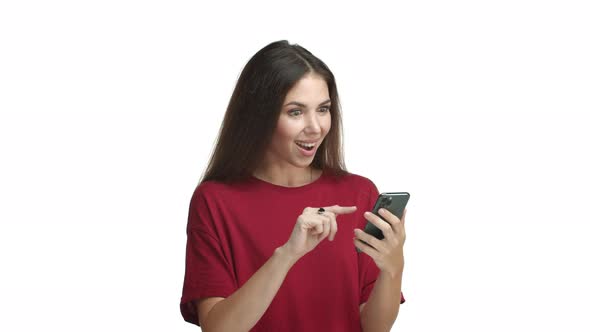 Video of Attractive Young Woman in Red Tshirt Browsing Through Internet Pages and Find Something