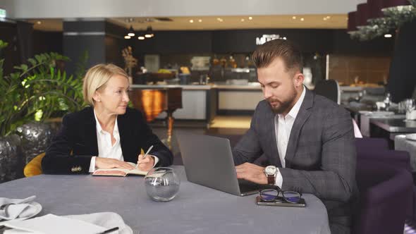 Business Partners Have Conversation and Talking at Meeting in Restaurant