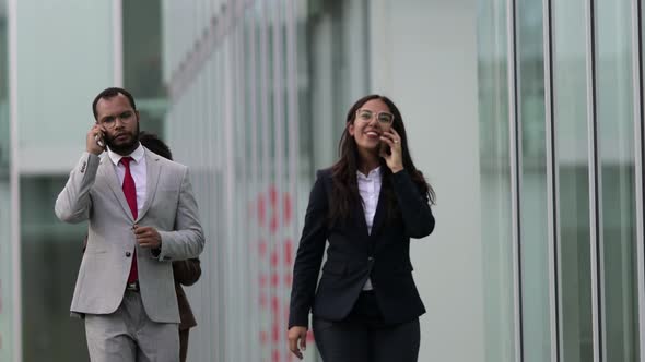 Cheerful Business Consultants Talking on Smartphones