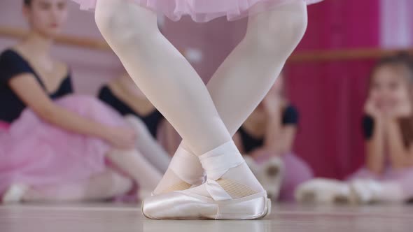 Ballet Training Ballerina Girls in Beautiful Dresses Sitting on the Floor and One of Them