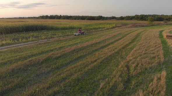 Farmer on Mini Tractor with Trailer