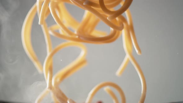 Camera follows cooking spaghetti in tomato sauce. Slow Motion. alt