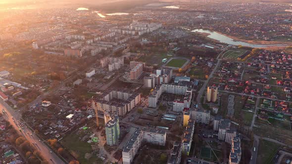 Flying Over City At Sunset