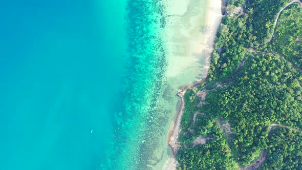 Tropical island beach background. turquoise sea, sandy beaches and palm forest, aerial Thailand