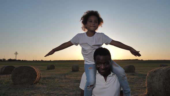 Smiling Father Walking with Girl on His Shoulders