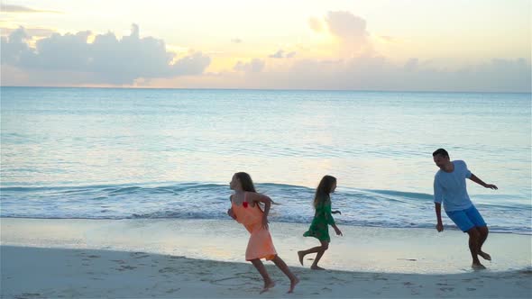 Father and Kids Enjoying Beach Summer Tropical Vacation at Sunset. SLOW MOTION