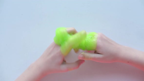 Girl Stretching Green Slime to the Sides