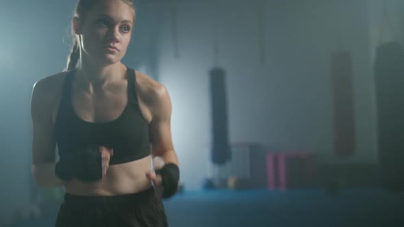 Female Fighter Warms Up and Trains His Punches Training Day in the Boxing Gym the Female Strikes
