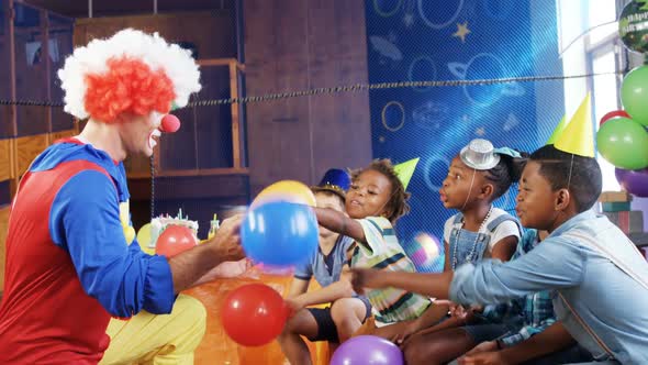 Clown playing with the kids during birthday party 