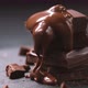 Chocolate pouring on chocolate bars on black slate background - VideoHive Item for Sale
