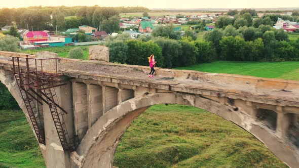 Lady Athlete is Running Along an Oldfashioned Bridge