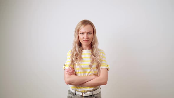 Portrait of a Disgruntled Girl with Crossed Arms on Her Chest