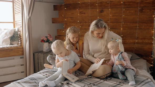 Female and Her Kids Reading Book Inside House