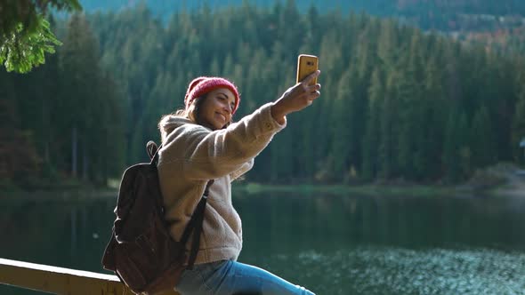 Female Hiker Photographer in Woods Shooting Selfie Lake View