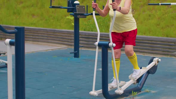 Senior Woman Grandfather 70 Years Old Doing Sport Training Exercising Workout on Orbitrek Playground