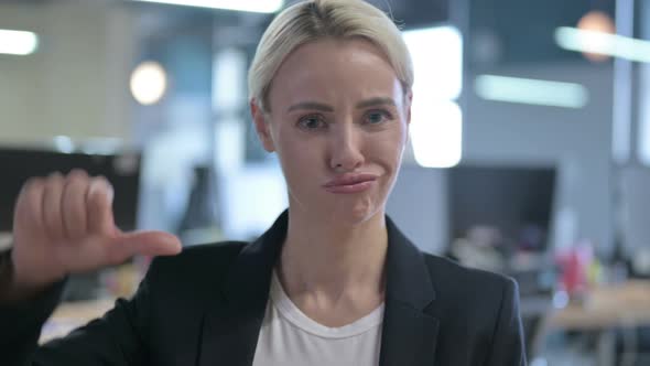 Portrait of Disappointed Businesswoman Showing Thumbs Down