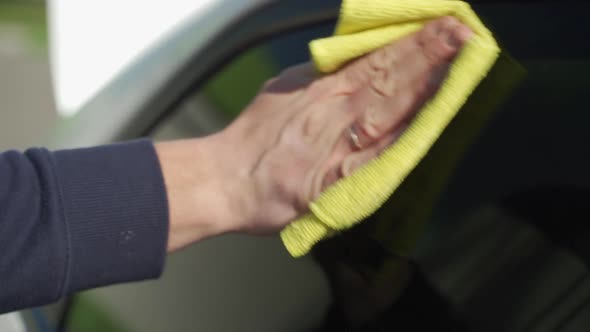 Auto Care Service Staff Cleaning Car Window Glass with Microfiber Cloth