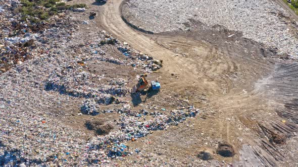 Garbage Trucks Unload Garbage in a City Landfill
