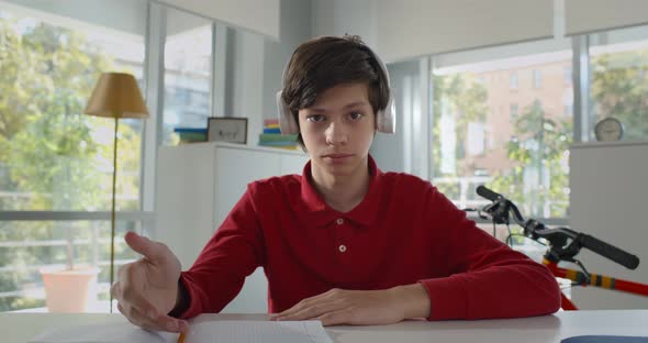 Portrait of Teen Boy in Headphones Look at Camera and Talk Having Online Lesson