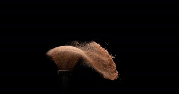 Make-up Brush spreading blush powder on black background, Slow motion 4K