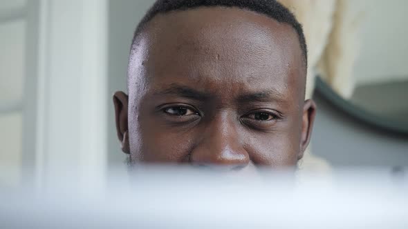 a Black Man Works at a Laptop Closeup of His Face