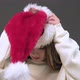 A girl puts on a Santa Claus Christmas hat. Merry Christmas - VideoHive Item for Sale