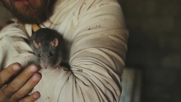 Crazy Terrible Maniac In Basement With Window Playing With Rat