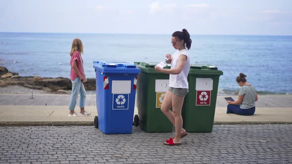 Wide Shot of Young Woman Tearing Paper Throwing Garbage in Special Container for Trash Separation on
