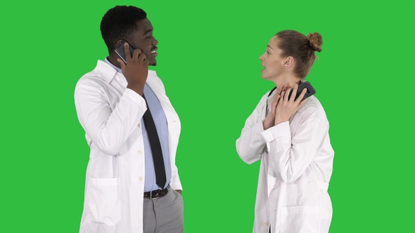 Female and male doctor using mobile phones making calls