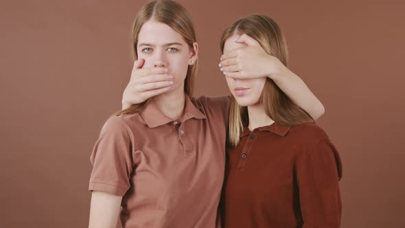 Identical Twins Posing for Camera