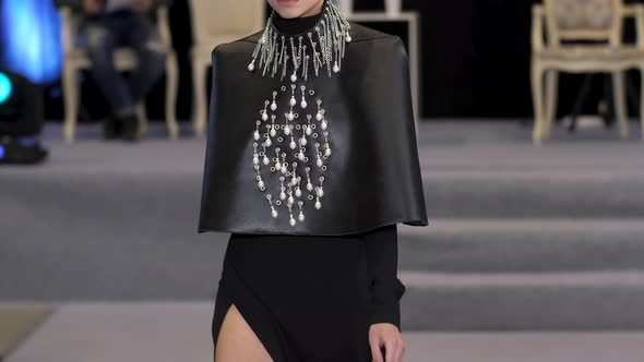 Blond Hair Model with Side Cut Jewelry Fringe Pattern Dress Walks on Podium
