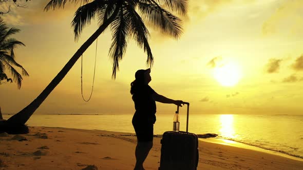 Woman tanning on beautiful seashore beach journey by blue water and white sand background of the Mal