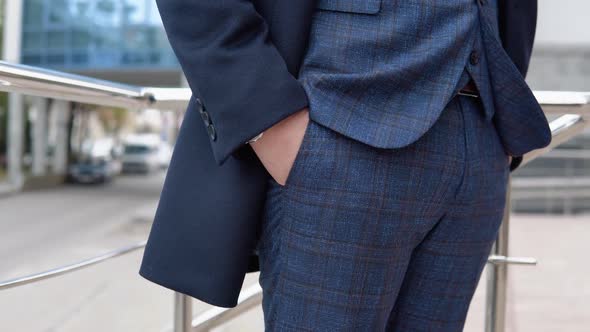 Closeup of a Elegant Businessman in Blue Jacket and Coat Near Office Center