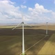 Aerial shot of power generating windmills over agricultural fields - VideoHive Item for Sale