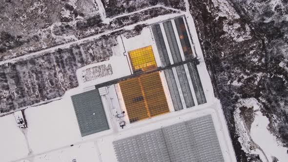 Large Glass Greenhouses on the Outskirts of the City in Winter Top View