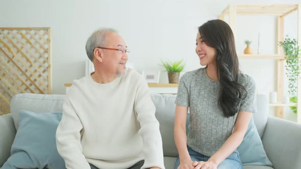 Portrait of Asian beautiful daughter hugging and sit with older father.