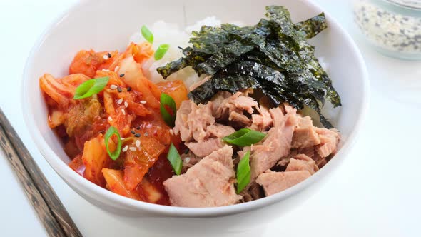 Kimchi tuna rice salad in white bowl.