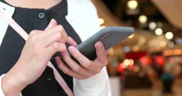 Woman use of mobile phone in shopping mall