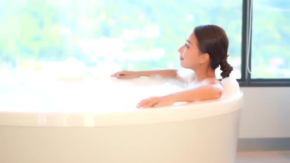 Young asian woman relax in bathtub