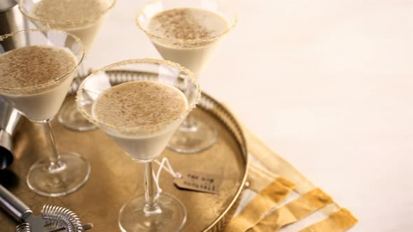 Holiday eggnog cocktail with dark rum and milk garnished with nutmeg.