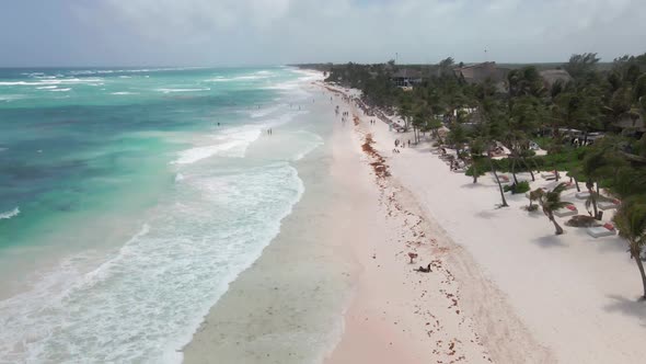 Aerial drone shot over beach in Tulum, Mexico. Sunny and windy.