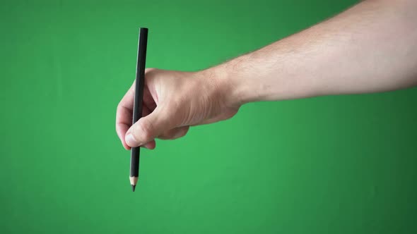 Man Holding Pencil In His Hand Isolated On Chroma Key Green Screen Background