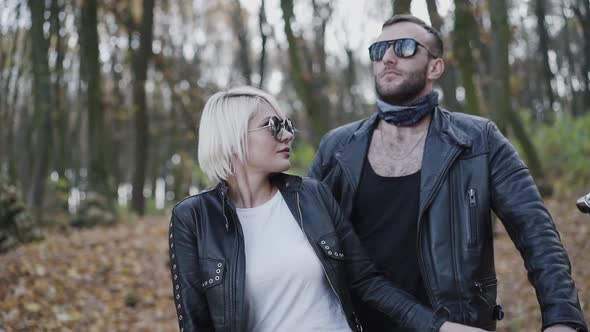 Happy Woman Touches Beard of Her Man Stands Behind Her and Smiles