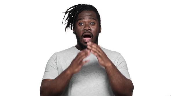 Portrait of Stunned African American Man with Afro Hairdo Expressing Surprise and Covering Open