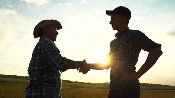 Two Male Farmers Shake Hands