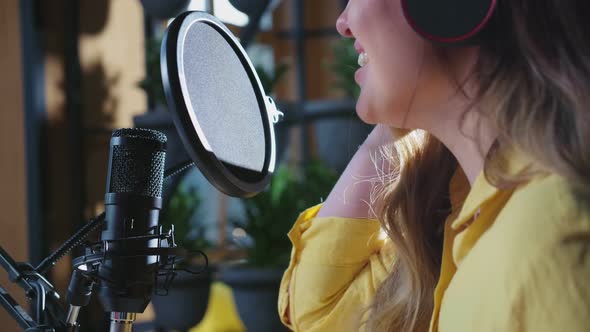 Young Cute Woman Singing Into Microphone