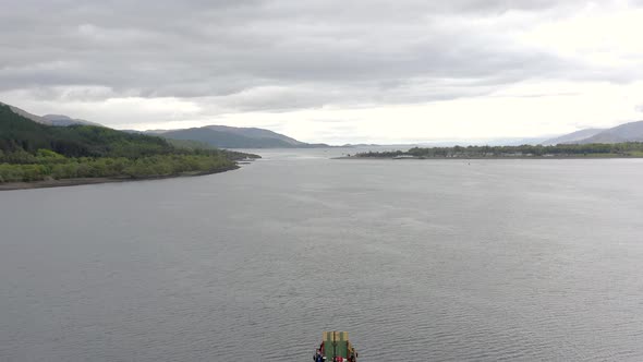 A Commercial Ship is Seen Traversing A Sea Loch in Scotland