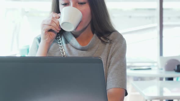 Young Woman Video Calling Someone Using Her Laptop