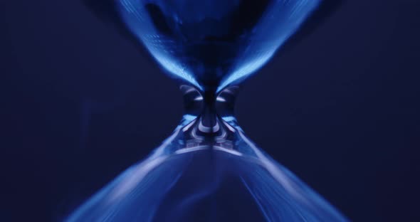 Hourglass on blue colored background