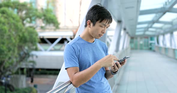 Man using smart phone in city